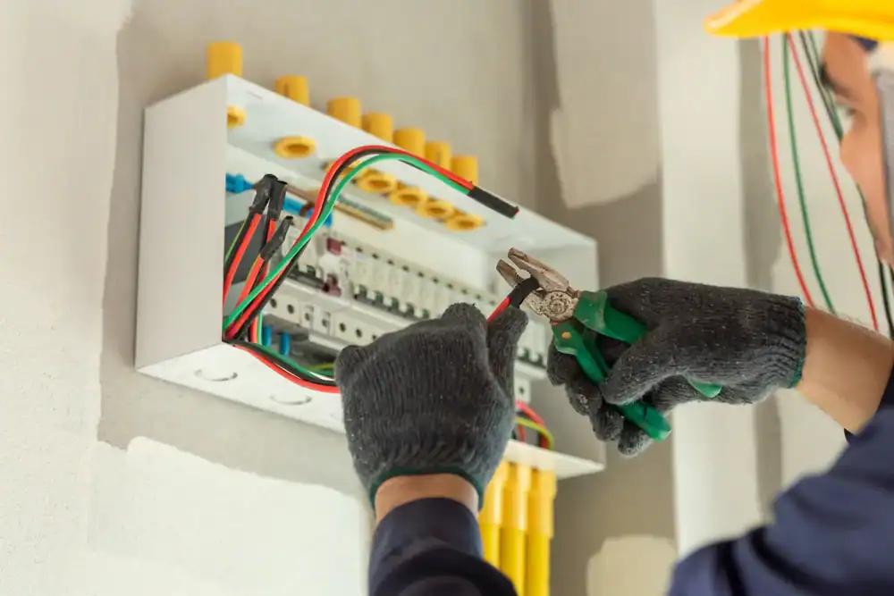 Electrician servicing a circuit box in Tarrant County, Texas, ensuring proper connections and safety for residential electrical systems at Carroll Service