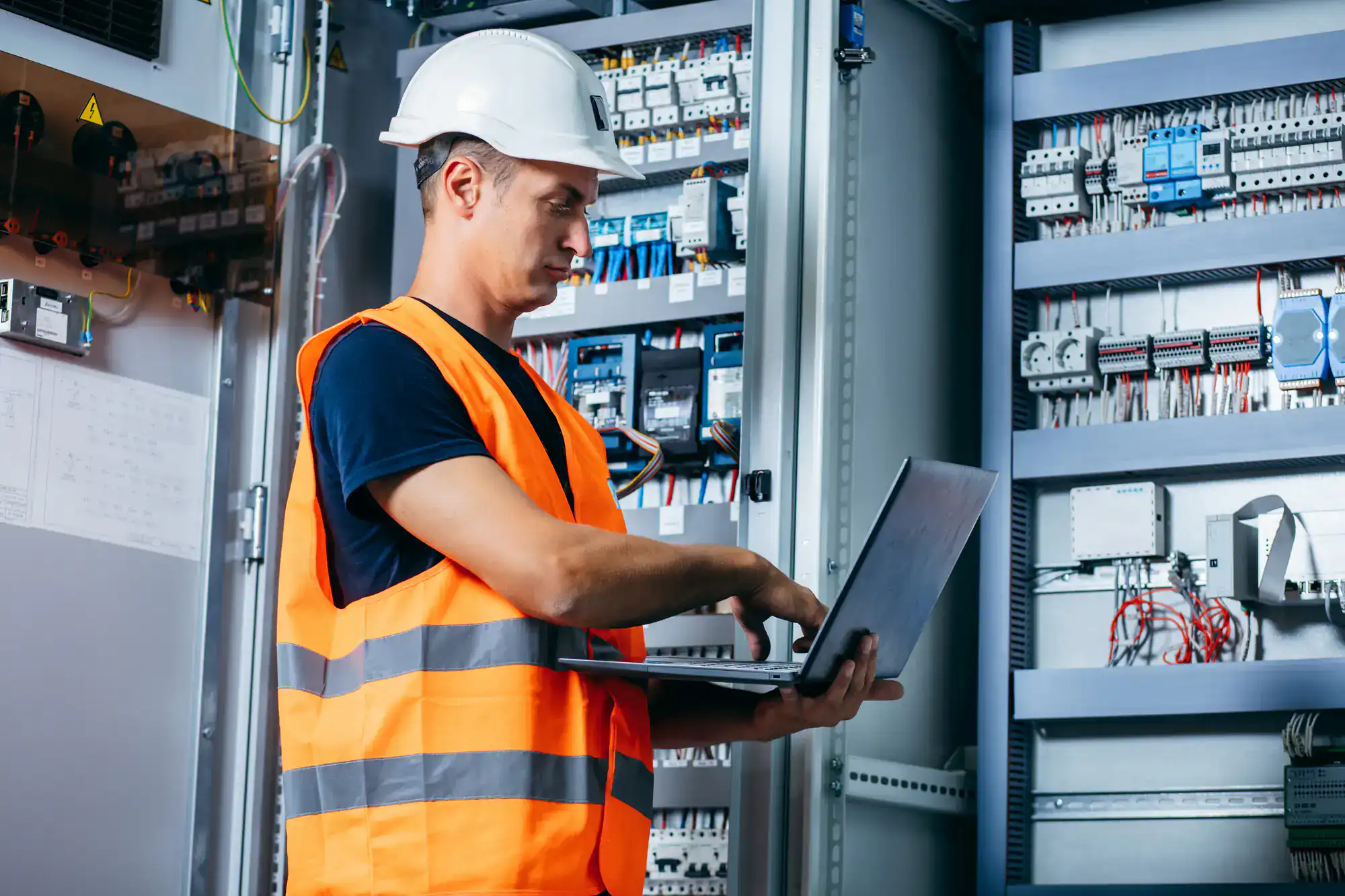 Electrician adjusting a complex control panel in Dallas County, Texas, ensuring safe and efficient electrical system operation for Carroll Service Co