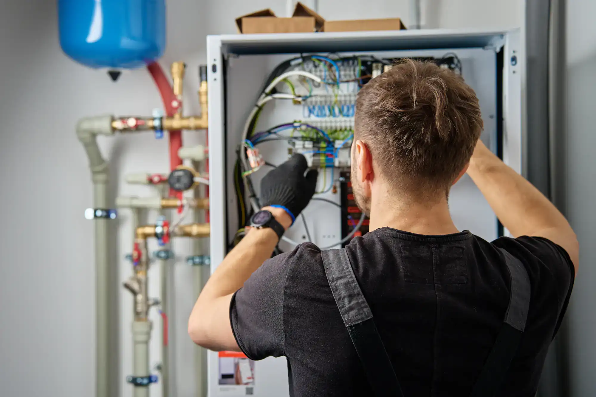 Certified electrician performing a thorough home electrical inspection in Dallas County, Texas, checking wiring, outlets, and circuit breakers for safety and compliance.